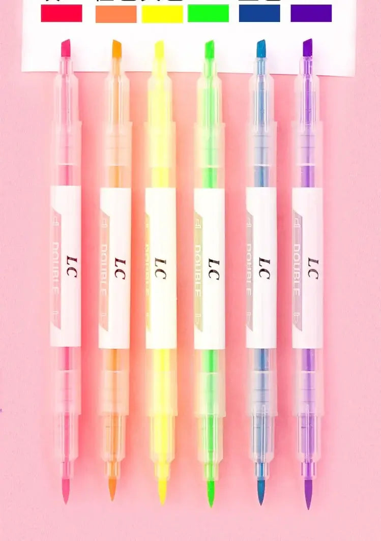Set of colorful pens with 'LC' branding on a pink background