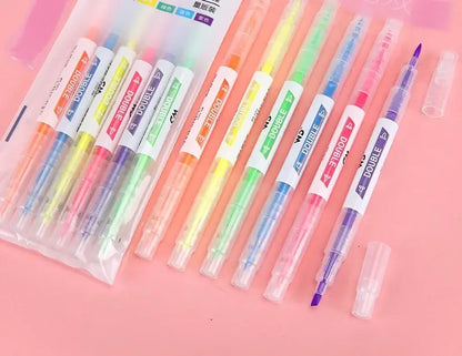 Set of colorful markers with caps on a pink background