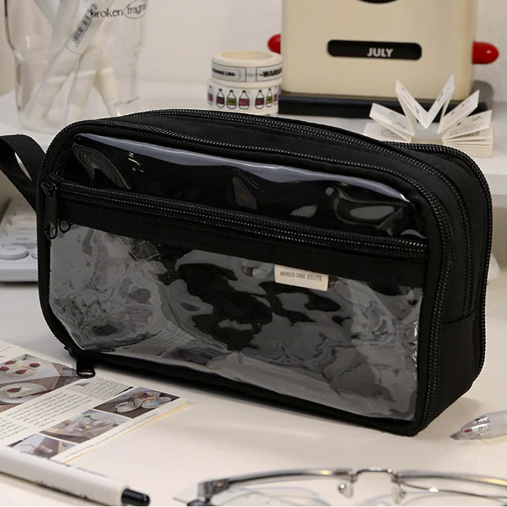 Black transparent pouch on a desk with office supplies in the background