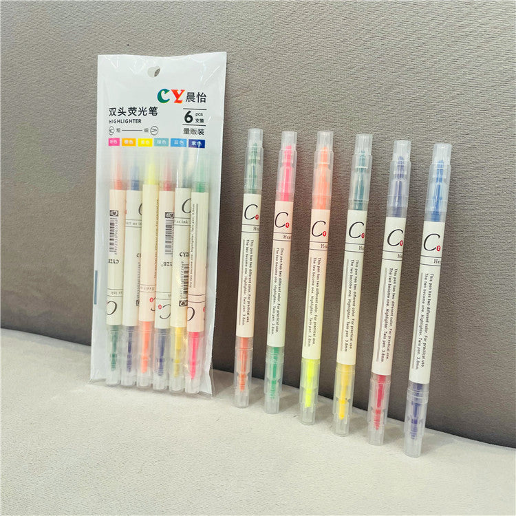 Set of colorful highlighters with packaging on a gray background