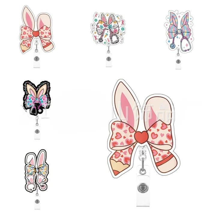 Set of decorative bow-shaped badge holders with various designs on a white background