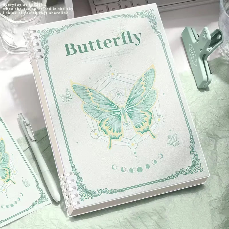 Notebook with butterfly design and text on a marble surface