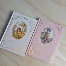 Two decorative notebooks with illustrated covers on a light background