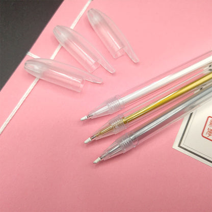 Set of clear pen refills on a pink surface