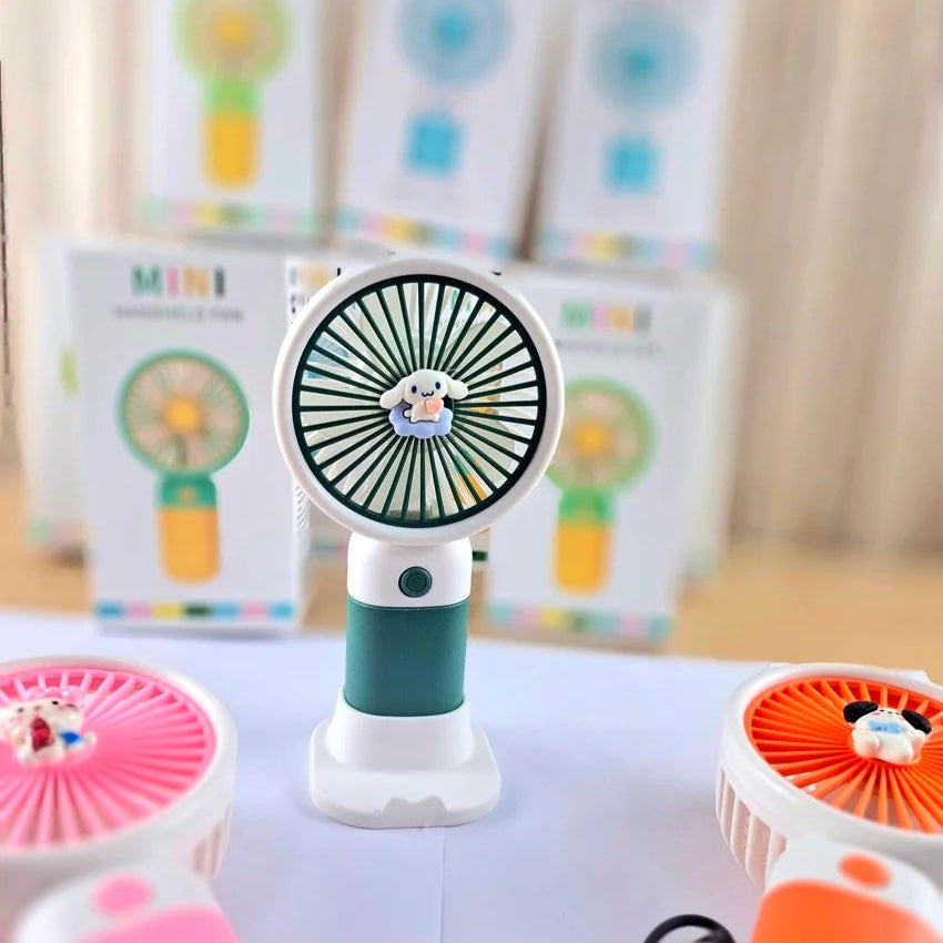 Colorful handheld fans on a table with a blurred background