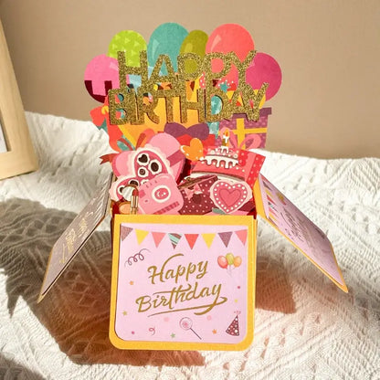 Colorful birthday card with balloons and a teddy bear on a textured surface