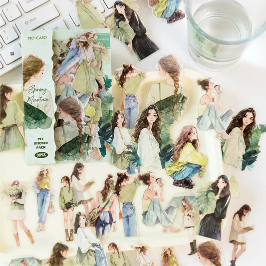 Sticker pack with illustrated women in various poses on a desk with a keyboard and glass of water.