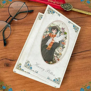Harry Potter book with cover illustration on a wooden surface with glasses and a key.