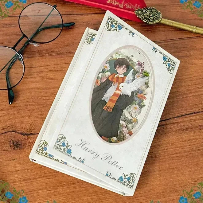 Harry Potter book with cover illustration on a wooden surface with glasses and a key.
