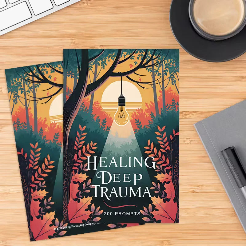 Book titled 'Healing Deep Trauma' on a wooden desk with a cup of coffee and keyboard.
