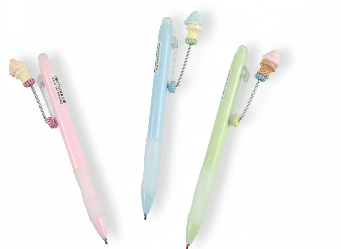Three pastel-colored pens with small figurines on a white background