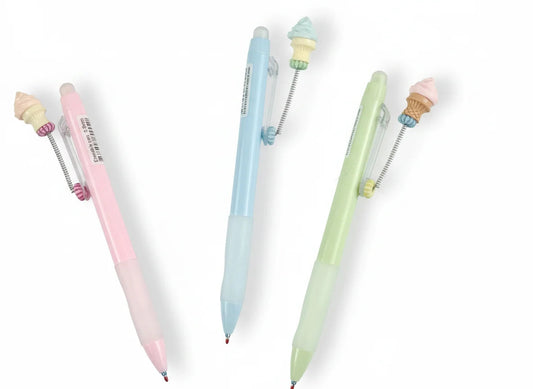Three pastel-colored pens with small figurines on a white background