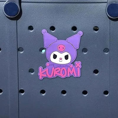 Kuromi character sticker on a dark surface with circular cutouts