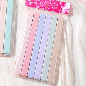 Set of colorful sticky notes in a clear plastic case with a floral-patterned cover.