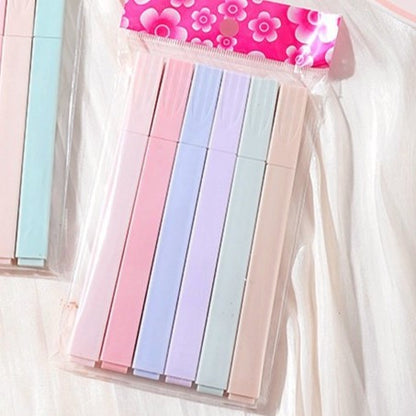 Set of colorful sticky notes in a clear plastic case with a floral-patterned cover.