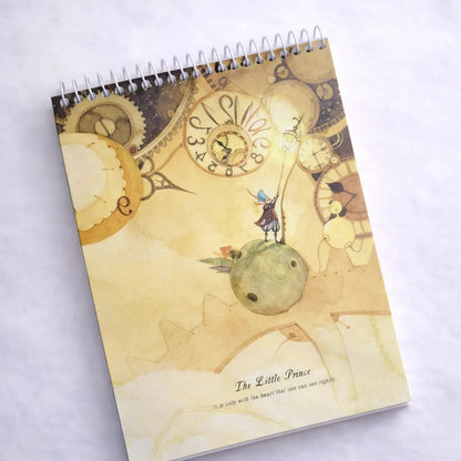 Notebook with a decorative cover featuring gears and a small figure on a white background