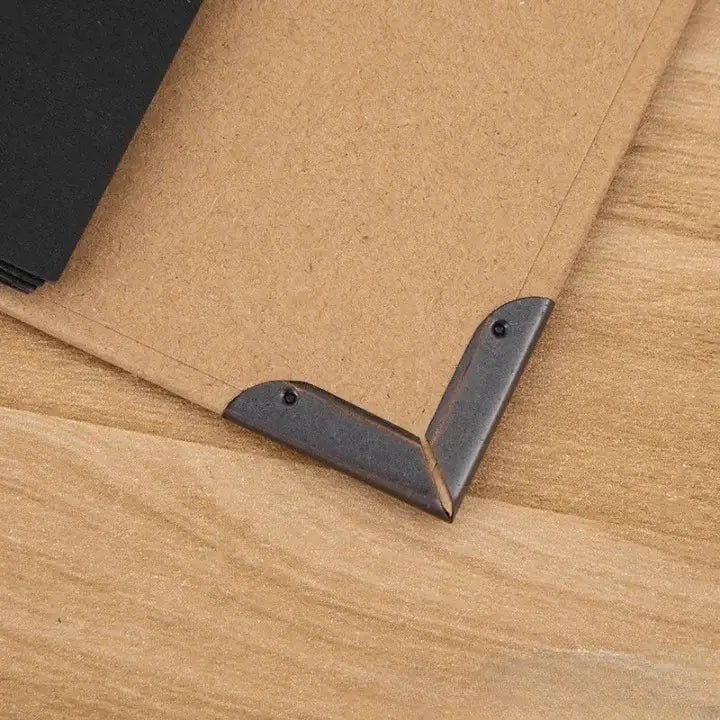 Metal corner brackets on a cardboard surface