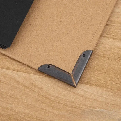 Metal corner brackets on a cardboard surface