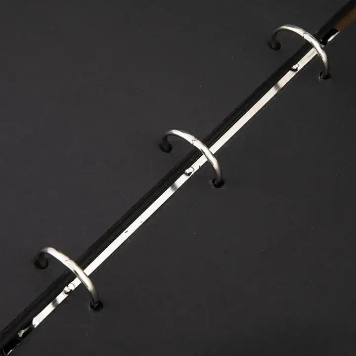 Metallic rod with circular hooks on a dark background