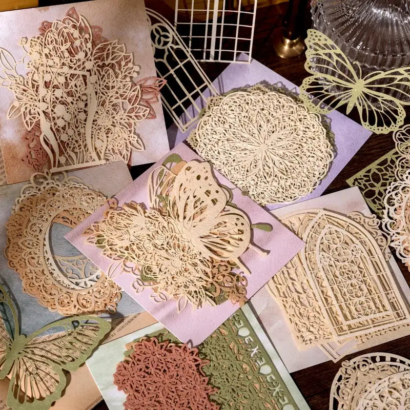 Collection of decorative paper cutouts with intricate designs on a wooden surface.