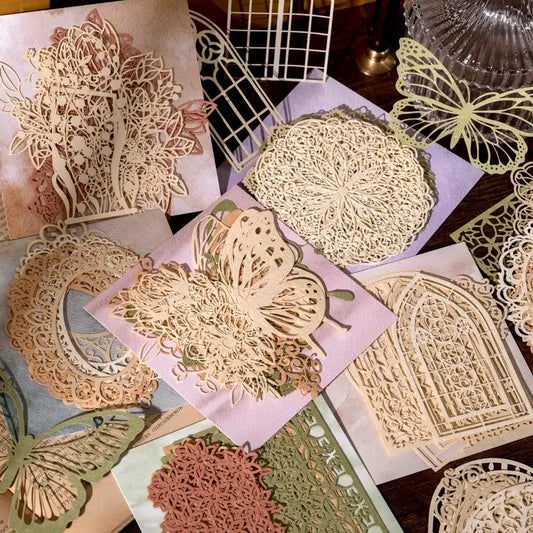 Collection of decorative paper cutouts with intricate designs on a wooden surface.