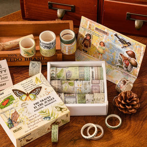 Collection of washi tape rolls and decorative boxes on a wooden surface