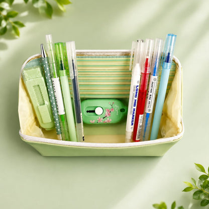 Desk organizer with stationery items on a light green background