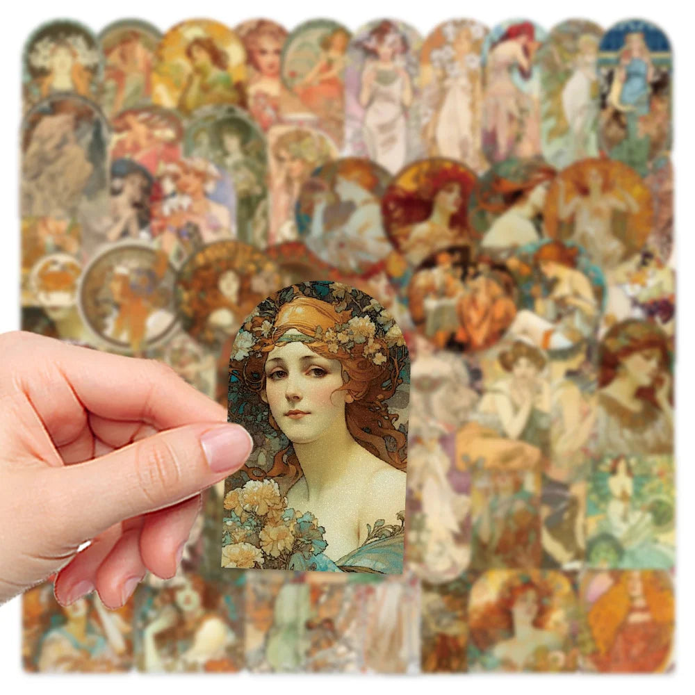 Collection of vintage-style cards with artistic illustrations, held by a hand.