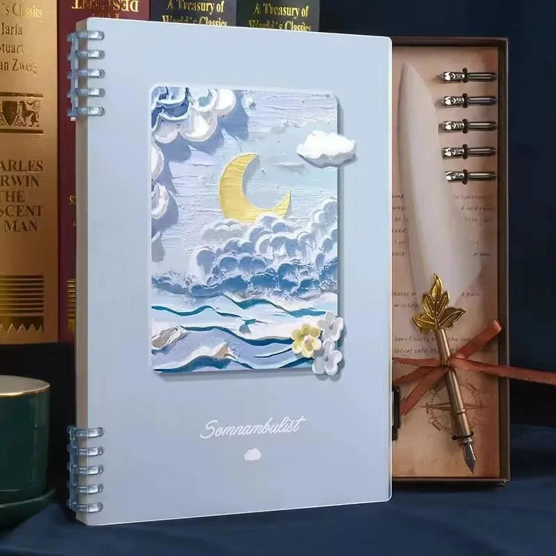 Notebook with artistic cover featuring a moon and clouds, placed on a surface with books and stationery items.