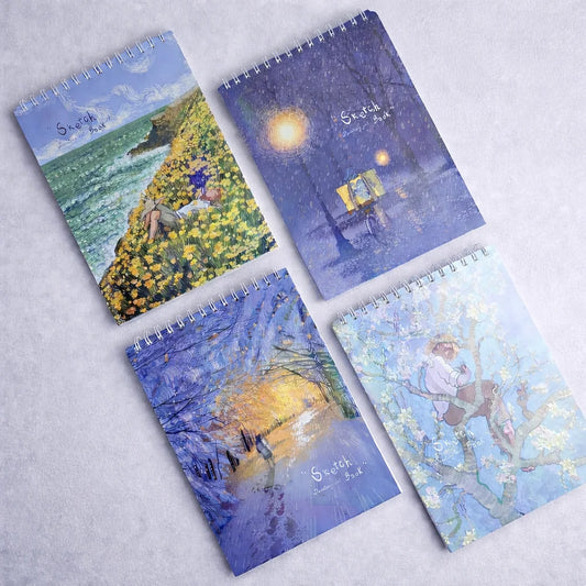 Four notebooks with artistic covers on a light gray background