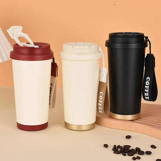 Three insulated coffee cups with different designs on a beige background