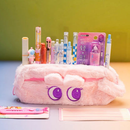 Pink pencil case with cartoon face design on a colorful background