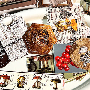 Collection of decorative items including coasters and a framed picture on a white surface.
