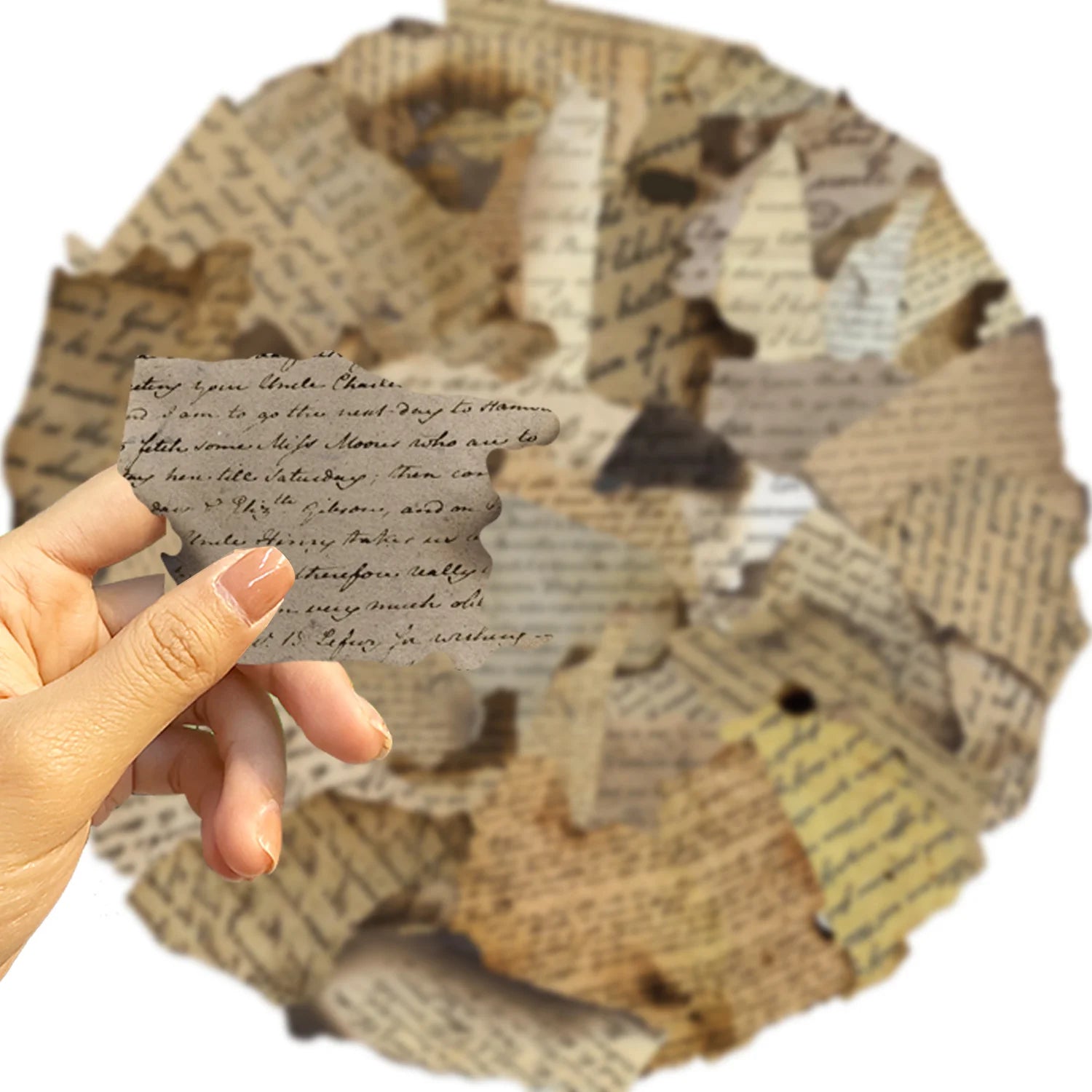 Hand holding a piece of paper with text over a decorative item made from recycled paper.