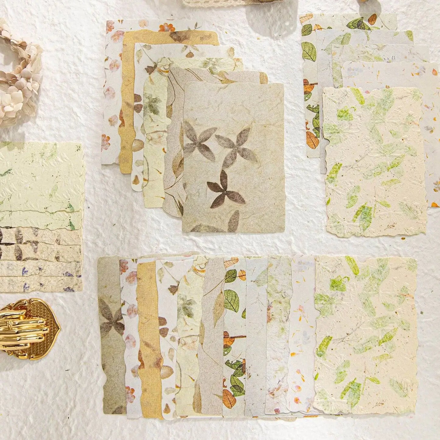 Collection of square paper samples with floral patterns on a textured white background