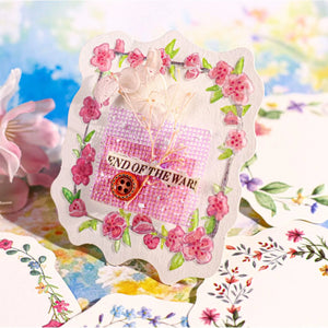 Decorative card with floral designs and text 'End of the War!' on a colorful background