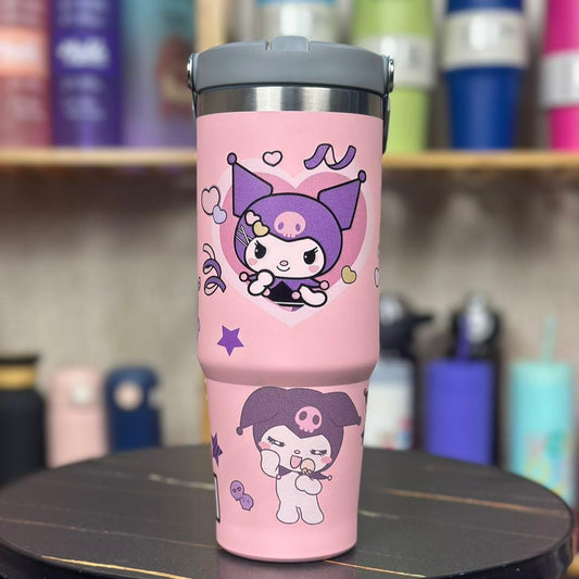 Pink tumbler with cartoon character design on a black stool against a colorful background