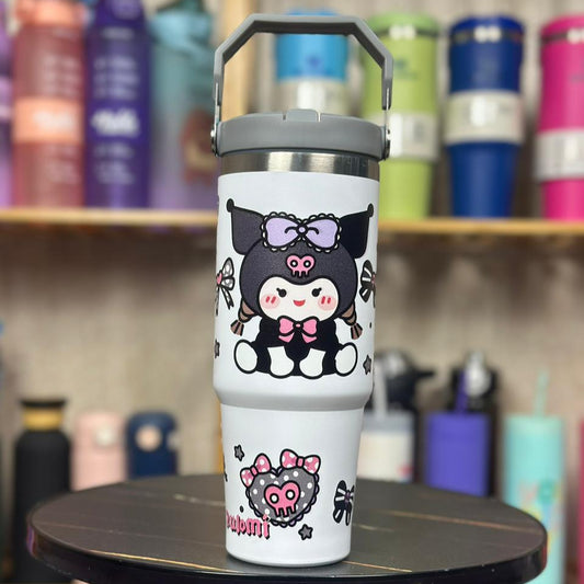 White tumbler with cartoon character design on a black stool against a colorful background of similar tumblers.