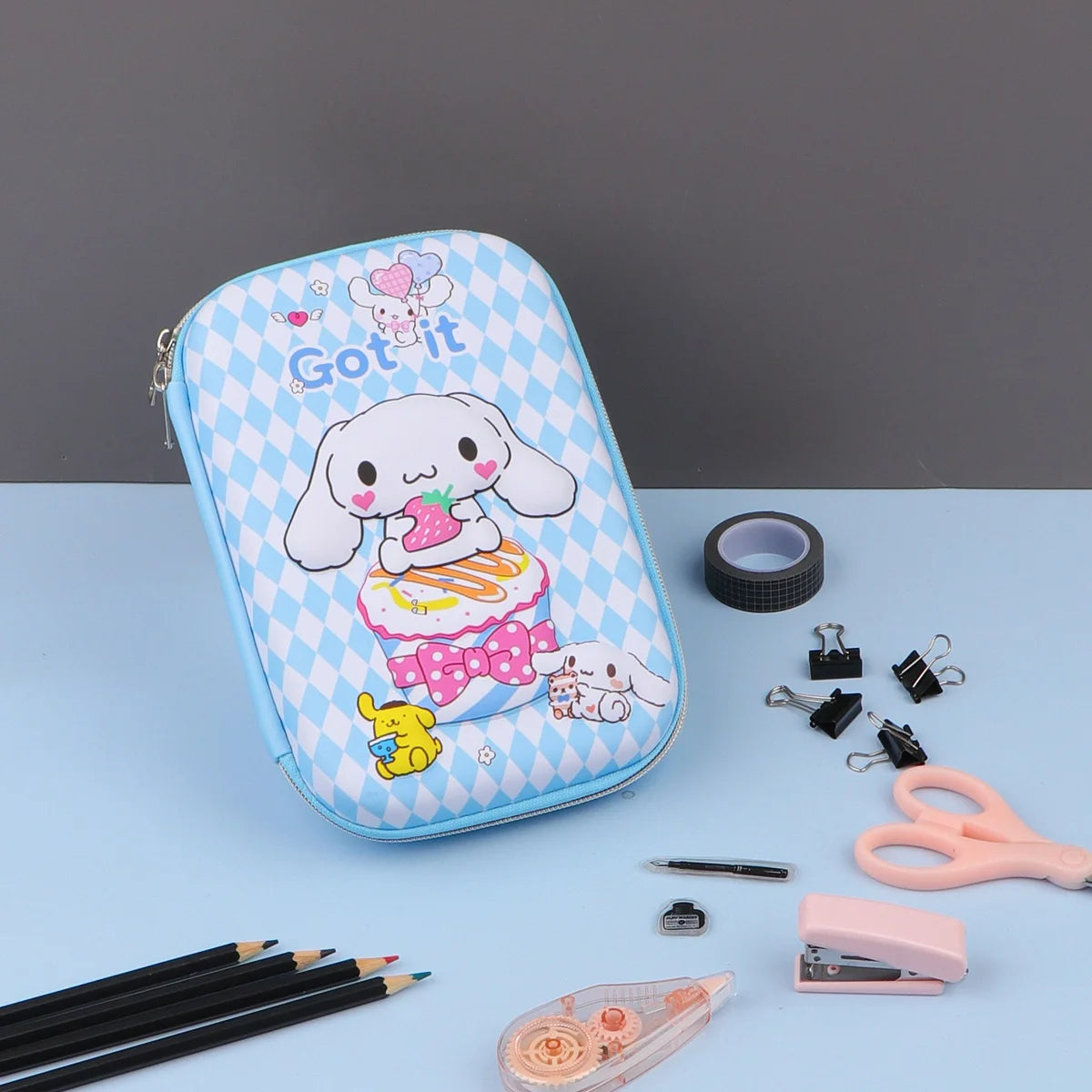 Three Sanrio 3D series pencil cases with character designs, accompanied by stationery items such as pencils and erasers.