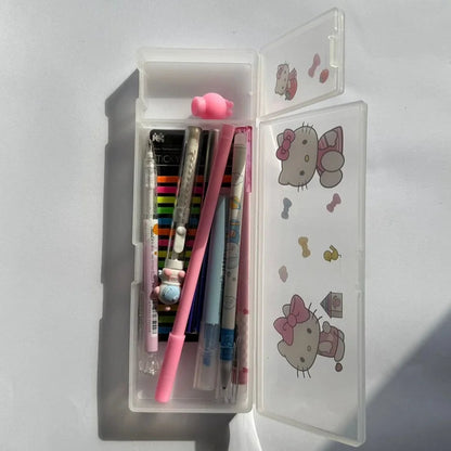 Pencil case with stationery items including pens and a ruler, featuring Hello Kitty illustrations on a white background.