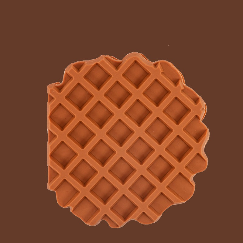 Brown waffle-patterned object on a brown background