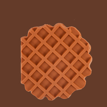 Brown waffle-patterned object on a brown background