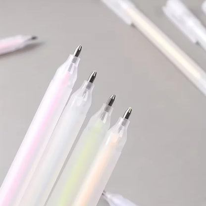 Three iridescent pens with metallic tips on a light gray background