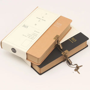 A closed planner journal with a plain beige cover, a metal lock attached to it, and a key lying next to the lock.