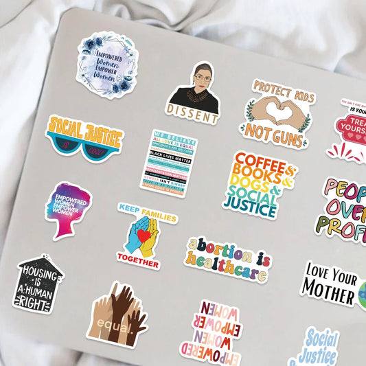 Collection of political and social justice-themed stickers on a laptop