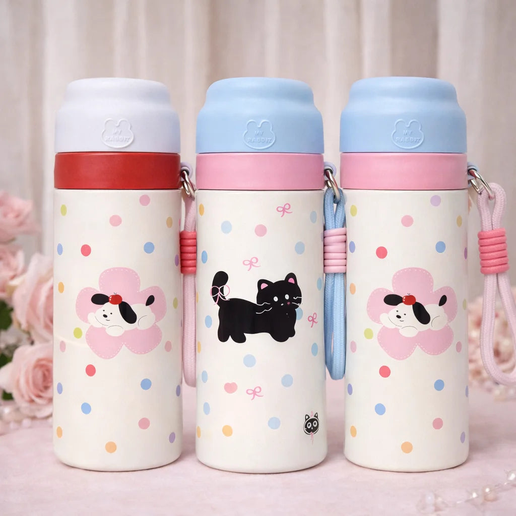 Three colorful water bottles with cartoon designs on a light background