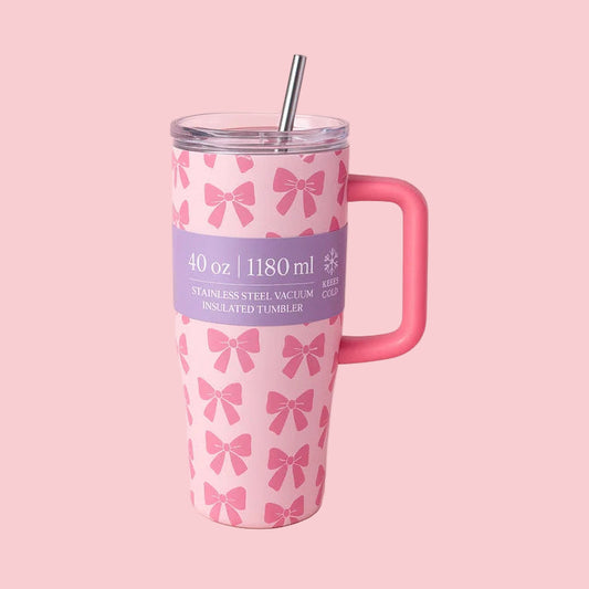 Pink tumbler with bow pattern and pink handle on a pink background