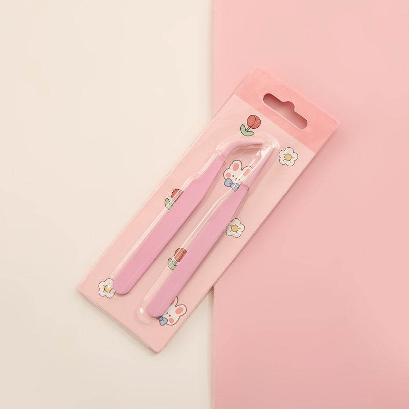 Pink nail clippers with a cute design on a pink background