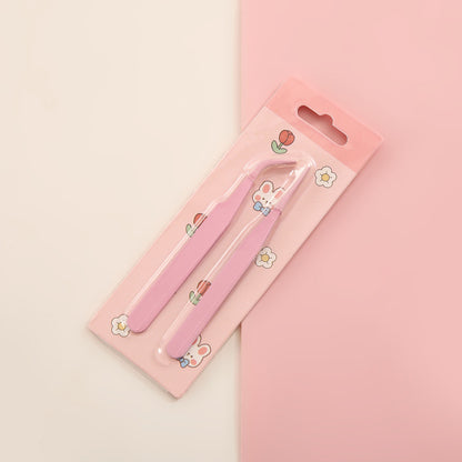Pink nail clippers with a cute design on a pink background