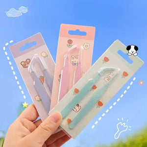 Three small tools in their packaging held by a hand against a blue sky background